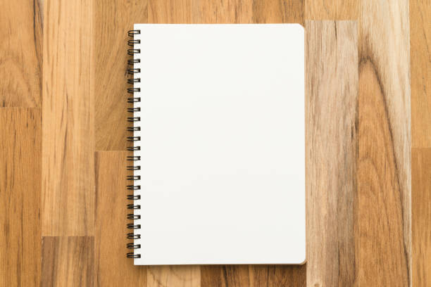 istock Flat lay of open blank spiral notepad or notebook on wooden table background. 1615899613