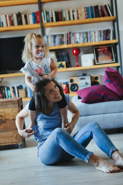 istock Mom, daughter play; physical joy, learning love 1615941321