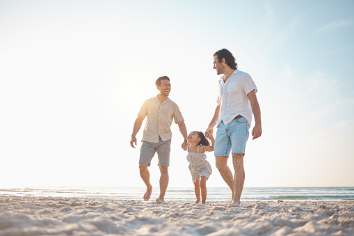 Gay couple, travel and holding hands with family at beach for seaside holiday, support and mockup. Summer, vacation and love with men and child in nature for lgbtq, happiness and bonding together