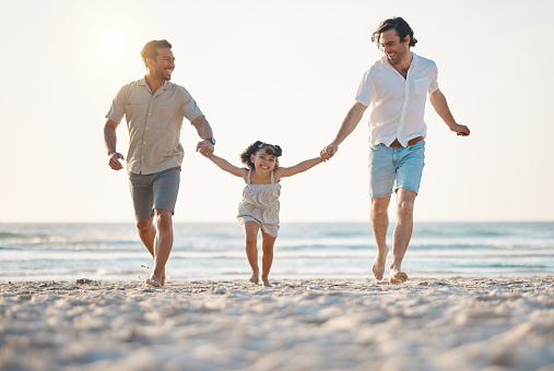 Gay couple, running and holding hands with family at beach for seaside holiday, support and travel. Summer, vacation and love with men and child in nature for lgbtq, happiness and bonding together