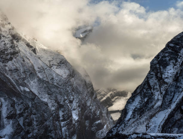 Snowcapped mountains and clouds in Himalayan valley of Annapurna mountain range in Nepal