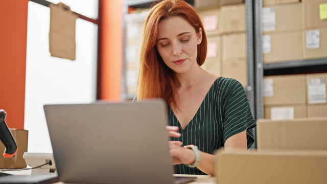 Young redhead woman ecommerce business finishing to work relaxed with hands on head at office