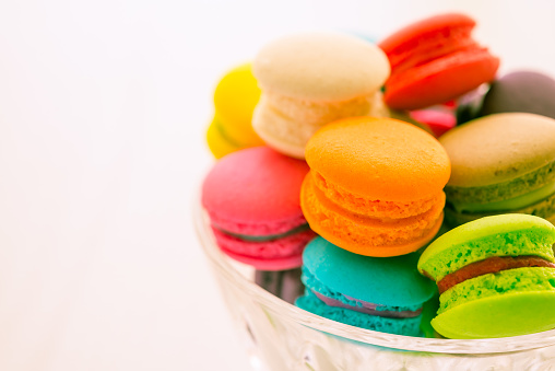 Colorful France macaroons in glass bowl color tone effect. Dessert food, design concept.