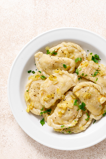 Homemade pierogi, dumplings, varenyky or vareniki with cabbage, top view