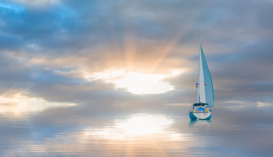 A white sailing yacht (boat) on the calm sea with storm clouds