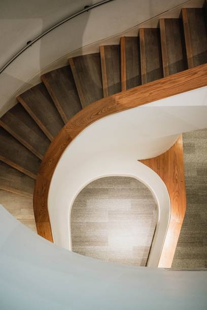 istock Winding wooden staircase inside a building 1615988366