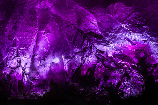purple fluorite crystal. macro detail texture background. close-up raw rough unpolished semi-precious gemstone
