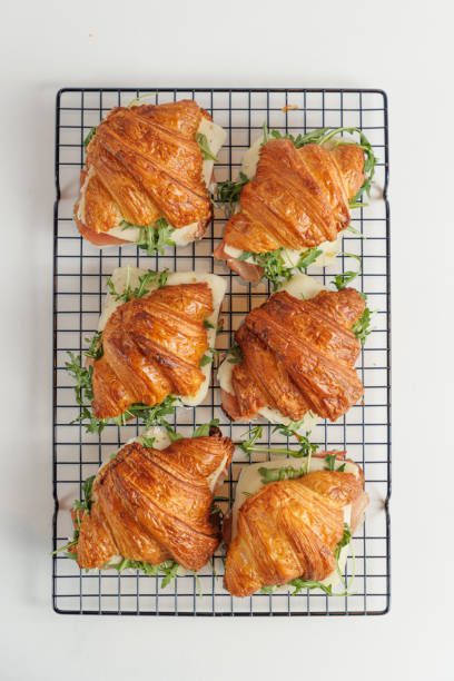 istock Directly above croissants filled with prosciutto, cheese and arugula 1615992161