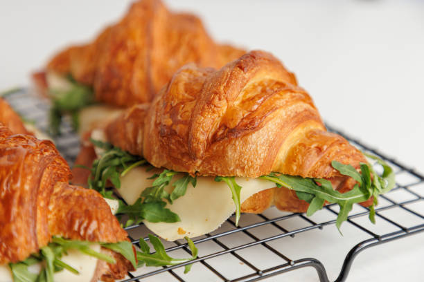 istock Close-up on croissants filled with pepperoni, cheese and arugula 1615992317