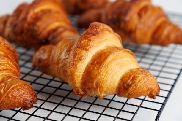 istock Close-up on crusty croissant on a grid 1615992730