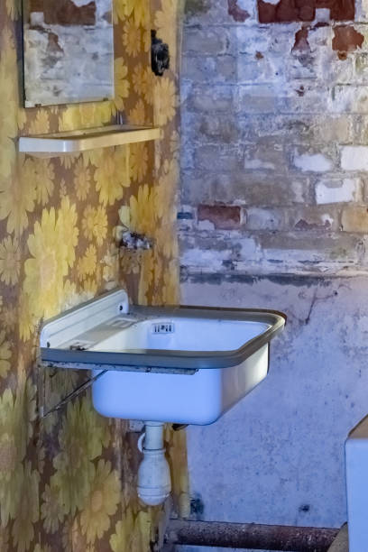 a dirty sink in an abandoned house