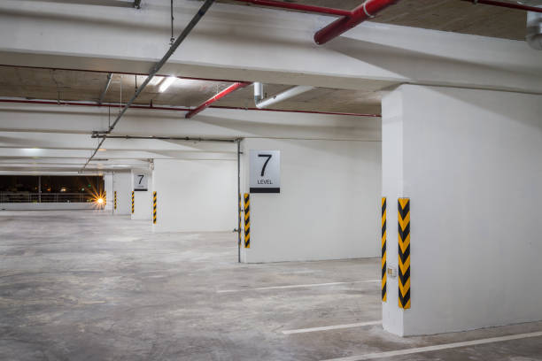 istock Parking garage interior in residential building at night with lighting. 1616018610