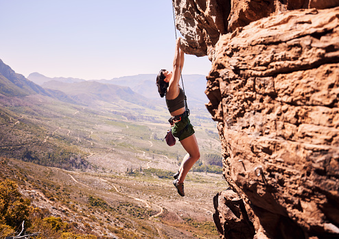 Sports, rock climbing and training with woman on mountain for fitness, adventure and challenge. Rope, workout and hiking with person on cliff in nature for travel, freedom and exercise mockup