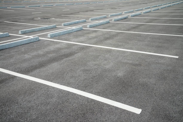 istock Empty space outdoor asphalt car parking lot (white line and concrete wheel stopper). 1616027884