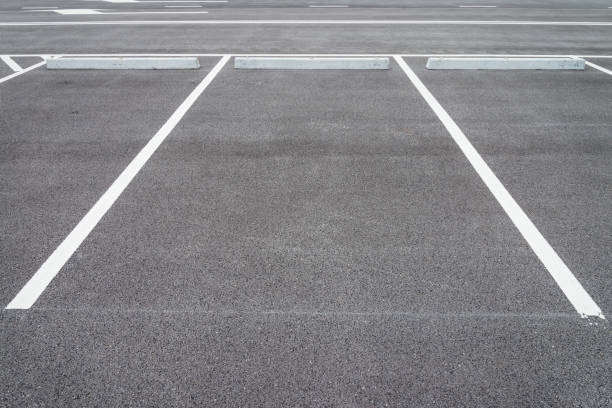 istock Empty space outdoor asphalt car parking lot (white line and concrete wheel stopper). 1616028431