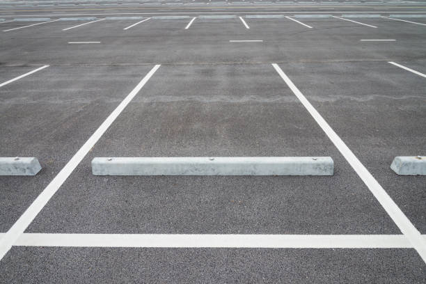 istock Empty space outdoor asphalt car parking lot (white line and concrete wheel stopper). 1616028958