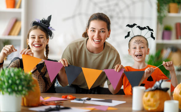 istock Happy family preparing for Halloween. 1616034697