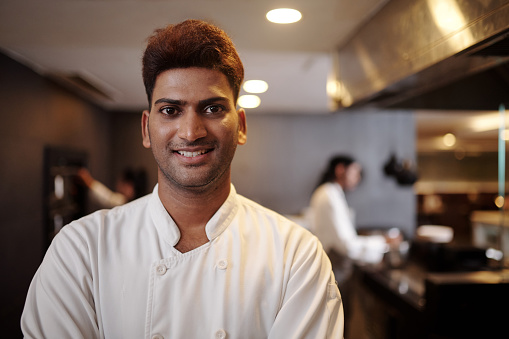 Portrait of smiling Indian hotel restaurant chef looking at camera