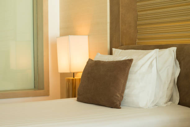 istock Bedroom with lamp lighting bedside table at night. 1616041745