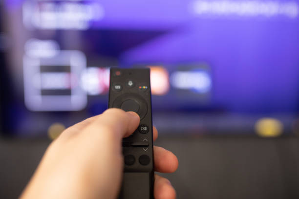 istock Tv online. Television streaming video. Online Multimedia video concept on TV set. Watching online TV with modern remote control in hand. 1616050430