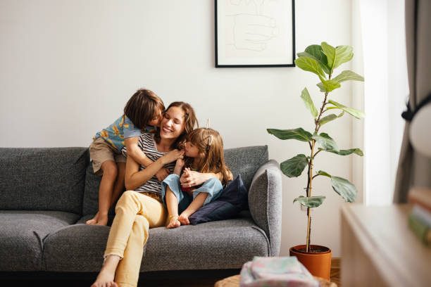 istock Happy Mother Bonding With Her Kids on the Sofa 1616061434