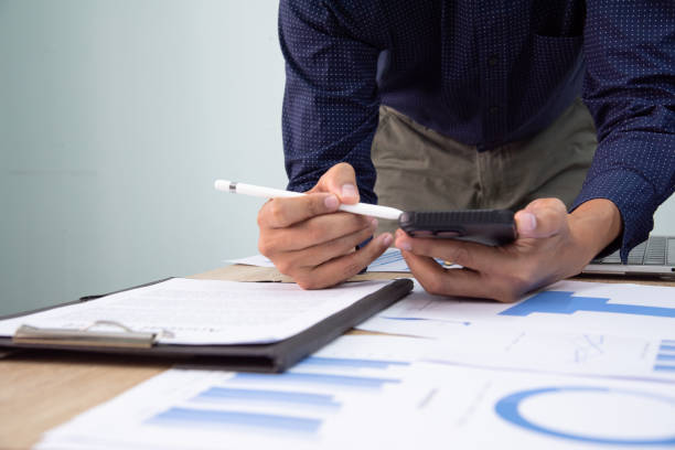 istock Businessman working at office with digital tablet, laptop computer, smart phone. Professional investor connection internet application online. Businessman review annual company report. 1616090560
