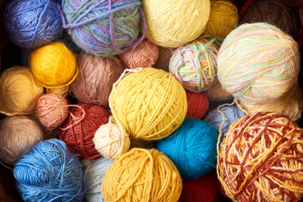 istock Knitting needles, colorful threads. Knitting pattern of colorful yarn wool in box. Top view. Knitting yarn for handmade winter clothes. Colorful background with yarn ball. 1616099669