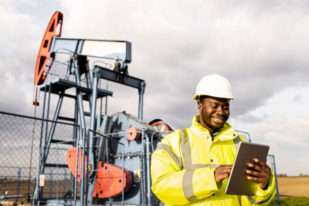 istock Maintenance engineer standing in oil field working on tablet computer. 1616109158