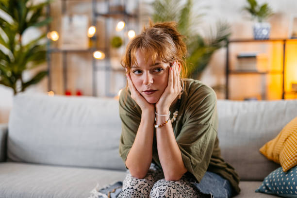 istock Sad Young Woman Sitting On The Sofa At Home 1616113933