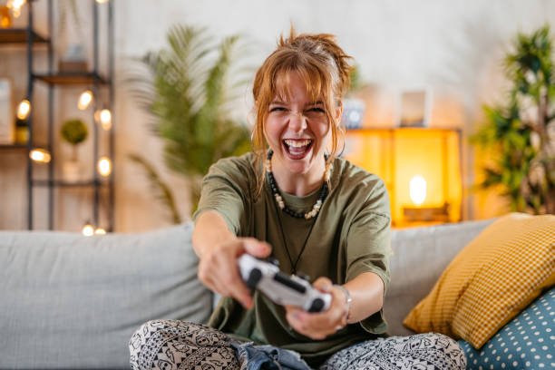 istock Young Woman Playing Video Games At Home 1616122145