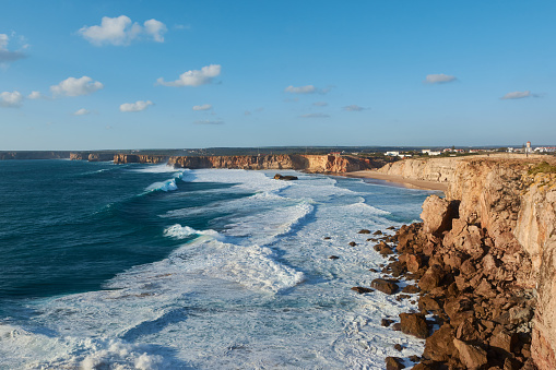 Typical Portuguese landscape - huge cliffs and giant stones washed by the waves of the Atlantic Ocean near Sagres, Portugal