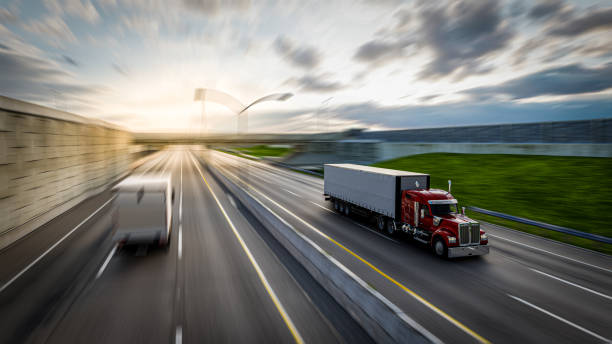 istock American style truck on freeway pulling load. Transportation theme. 3D illustration 1616136721