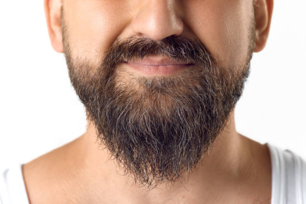 istock Cropped image of male face, beard against white studio background. Taking care after beard 1616148811