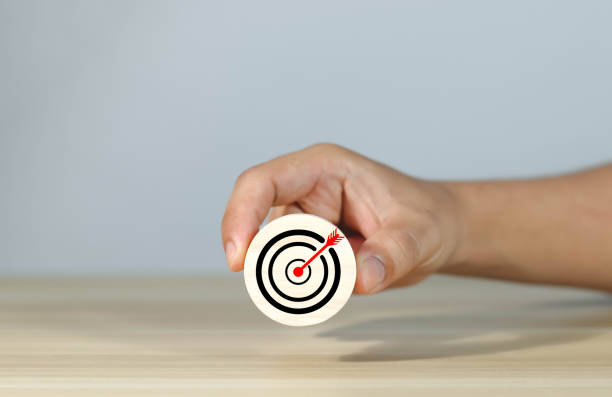 istock Target hand on wooden block 1616151136