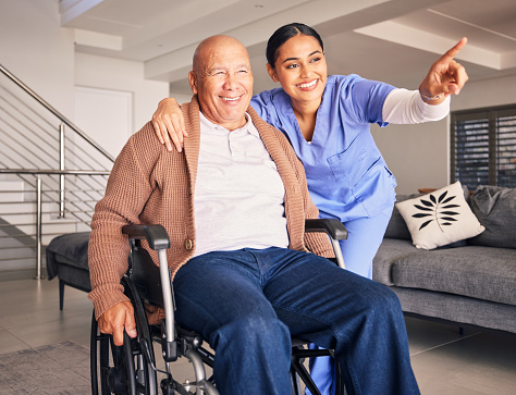 Old man, wheelchair or happy caregiver pointing or talking with healthcare support at nursing home. Smile, hope or positive nurse showing senior patient or elderly person with a disability for help