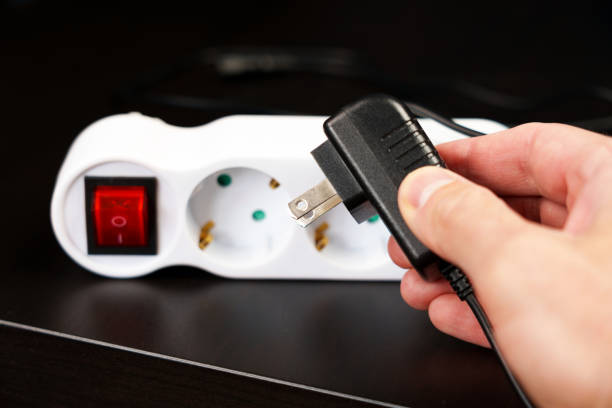 Error plugging an electrical plug into an outlet in a European hotel due to different equipment standards