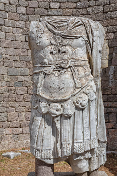 istock Emperor's armor close-up on an ancient Roman marble statue. Grunge bricks wall background. Vertical shot. Bergama (Ancient Pergamon), Turkey 1616198917