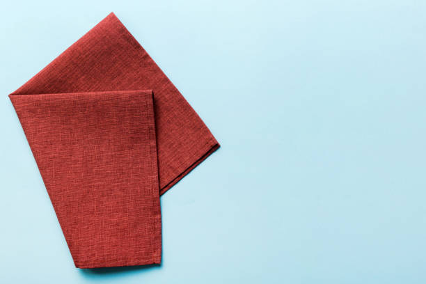 istock top view with red empty kitchen napkin isolated on table background. Folded cloth for mockup with copy space, Flat lay. Minimal style 1616232609