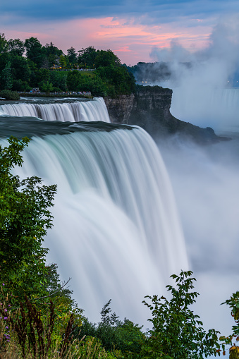 A long exposure photo waterfalls in the state park Niagara Falls in cloudy dusk.