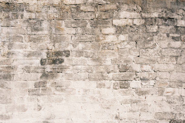 istock Part of a dirty old white brick wall 1616256934