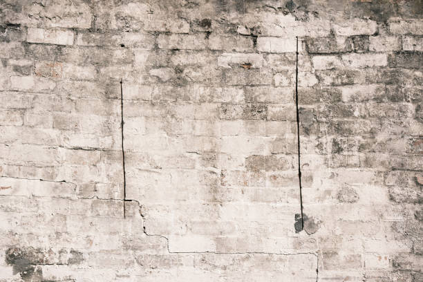 istock Part of a dirty old white brick wall 1616256941