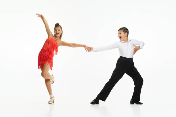 Boy and girl, children, friends making beautiful performance, dancing retro dance styles against white studio background Boy and girl, children, friends making beautiful performance, dancing retro dance styles against white studio background. Concept of childhood, hobby, active lifestyle, performance, art, fashion rockabilly boys stock pictures, royalty-free photos & images