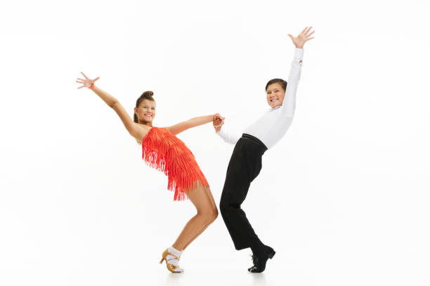 Talented, artistic, emotional kids, boy and girl in beautiful stage costumes dancing against white studio background Talented, artistic, emotional kids, boy and girl in beautiful stage costumes dancing against white studio background. Concept of childhood, hobby, active lifestyle, performance, art, fashion rockabilly boys stock pictures, royalty-free photos & images