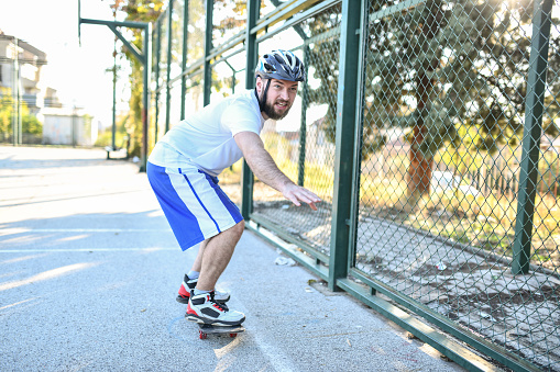 Bearded Male Maintaining Balance On Skateboard