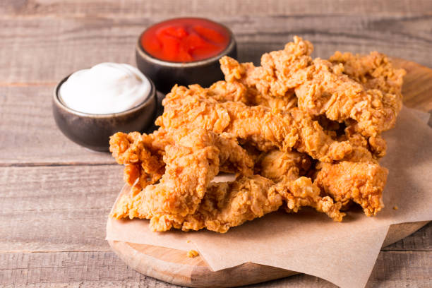 istock Crispy fried chicken breast strips with sauce 1616289578