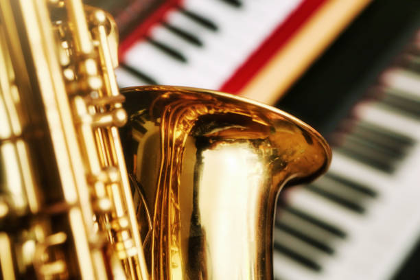 istock Golden alto saxophone with electronic keyboard instruments 1616289697
