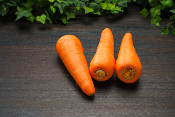 Fresh carrots on wooden table