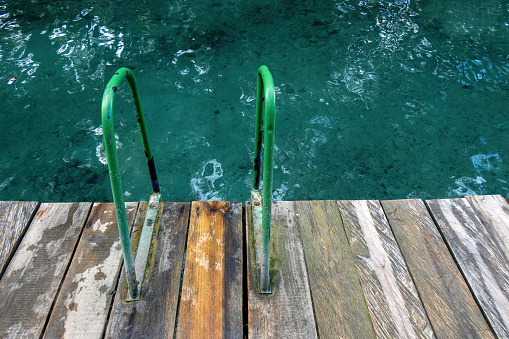 access to water after galvanized staircase construction. entrance for ice skaters in winter to the frozen pond. refreshment after sauna.stone slate, lawn, seat, sit, wide, natural pool resort, drone, camping equipment, landscaping, lined. net