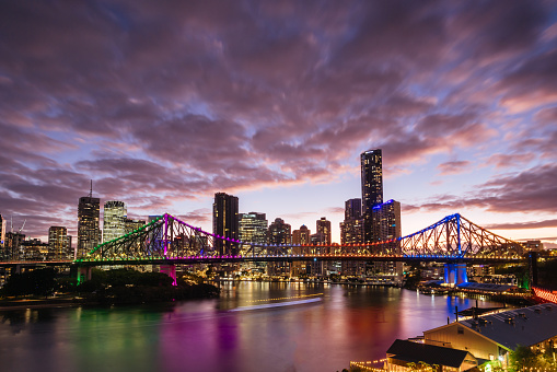 Brisbane skyline and Story Bridge from the suburb of New Farm and Wilson Outlook Reserve at dusk in Queensland, Australia.