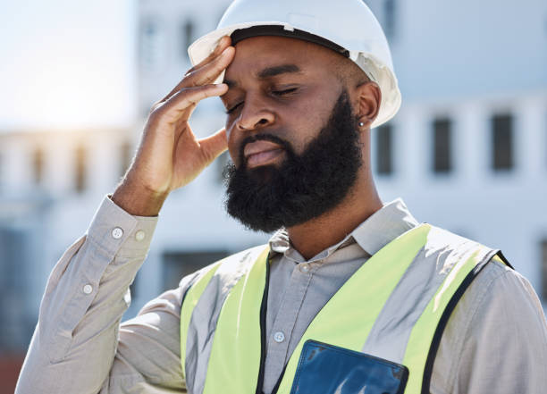 istock Construction, man and worker with headache, stress of building renovation and civil engineering mistake. Tired face of confused African contractor in burnout, crisis and industrial problem in city 1616344222
